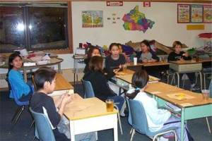 Shows young school children sitting in their classroom in the community of Nain. 
