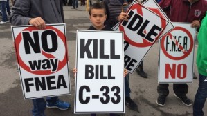 A child protests Bill C-33. Many Aboriginal leaders and community members do not agree with the bill and, despite the money that it would put into the education system, believe that it represents the Federal government having too much control over Aboriginal education.